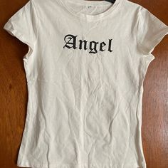 Shein White T-Shirt With Cap Sleeves. Angel In Black On Front. Size: Medium. New: Never Worn Before Without Tags Angel Shirt, Tops Shein, Word Shirts, Pinterest Closet, Shein Tops, Girls Life, School Shirts, White T Shirt, My Birthday