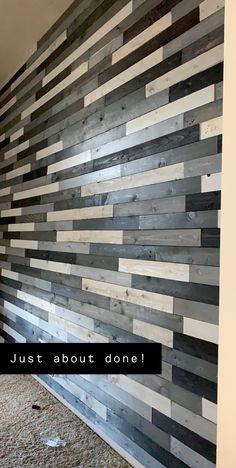 a wall made out of wooden planks with the words just about done