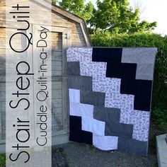 two quilts sitting next to each other in front of a wooden shed with text overlay