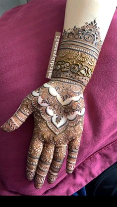 a woman's hand with henna on it