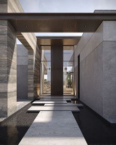 an entrance to a building with water running down the walkway and doors on both sides