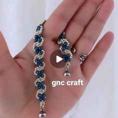 a hand holding a beaded bracelet with bells on it and the words gnc craft