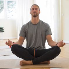 a man sitting in the middle of a yoga pose