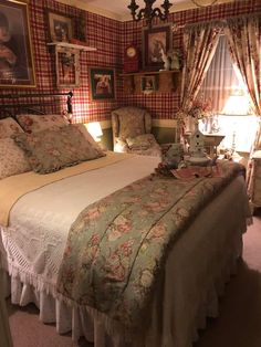 a bedroom with two beds and pictures on the wall above them, along with lamps