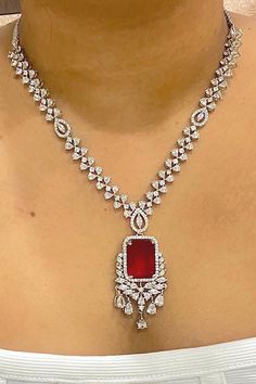 Gorgeous fine quality imitation jewellery  CZ Red with CZ diamonds studded necklace with white gold rhodium plating and matching Earrings Item contains: Necklace and earrings AAA quality cubic zirconia used. Highest quality and craftsmanship Necklace Fitting is adjustable Earrings Closure: Pushback Necklace Closure: chain with Hook Details-  -Handmade item -Delivery from a small business in India -Materials: white rhodium, stones, cz, zircon, American diamond -Jewellery type: Earrings, Necklace Dazzling Ruby Necklace With Diamond Cut, Ruby Jewelry With Diamond Accents For Party, Anniversary Diamond Gemstone Jewelry Sets, Red Cubic Zirconia Fine Jewelry Necklace, Red Cubic Zirconia Jewelry Sets For Celebration, Red Diamond Cut Diamond Necklaces, Fine Jewelry Ruby Necklace In Diamond White, Red Ruby Necklaces With Diamond Accents, Red Diamond Cut Necklaces