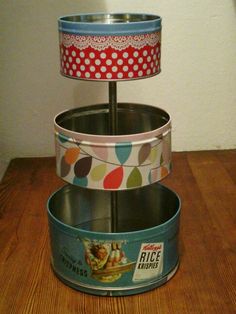 three tins stacked on top of each other with polka dot lampshade above them