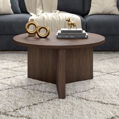 a living room with a couch, coffee table and two books on top of it