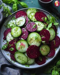 a white plate topped with cucumbers and radishes on top of a table