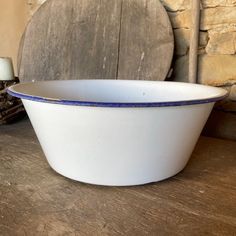 a white bowl sitting on top of a wooden table