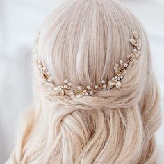 a blonde woman with long hair wearing a gold headpiece and pearls on it's side