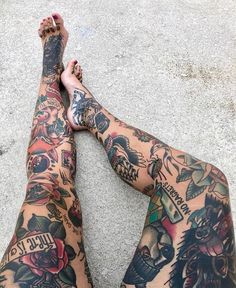 a person with tattoos sitting on the ground