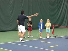 a man standing on top of a tennis court holding a racquet