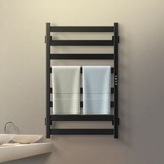 a bathroom with a sink, mirror and towel rack on the wall in front of it