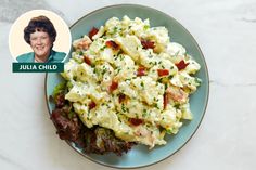 a blue plate topped with eggs and bacon next to a photo of julia child on the side