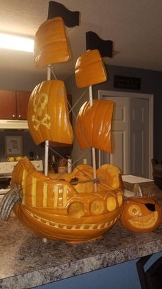 a boat made out of pumpkins sitting on top of a counter