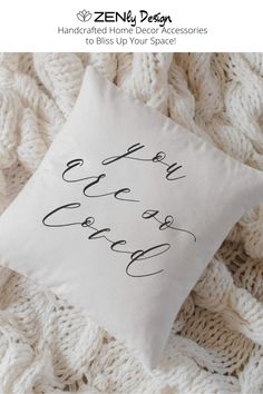 a white pillow with black lettering on it