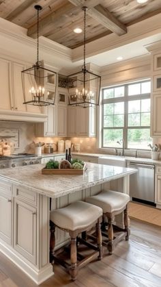 a large kitchen with white cabinets and an island