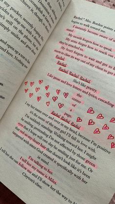 an open book with writing on it and hearts drawn on the pages in pink ink