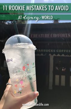 someone holding up a starbucks cup with the words disney world on it