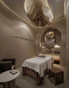 a spa room with two beds and a mirror on the wall that says make time for you