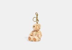 a teddy bear keychain is shown on a white background