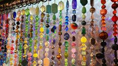 many different colored glass beads hanging from the ceiling