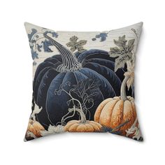 a blue and white pillow with pumpkins on it