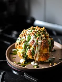 broccoli covered in cheese and other toppings on top of a brown plate