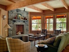 a living room with couches, chairs and a fire place in the fireplace area