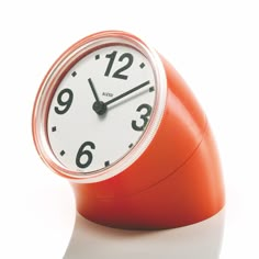 an orange alarm clock on a white background