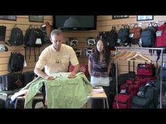 two people standing in a room with luggage