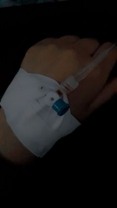 a person wearing a white shirt and holding an iv in their left hand with one arm wrapped around the other