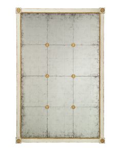 a white and gold framed mirror with four golden studs on the edges, against a white background