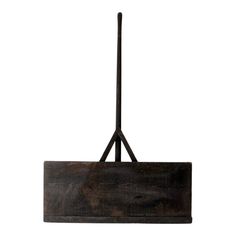 a wooden light fixture hanging from a metal pole with a black cord attached to it