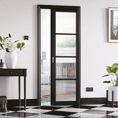 a black and white checkered floor with two vases on the end table next to it