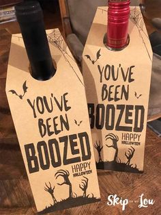 two halloween wine bottles with the words you've been boozed and happy on them