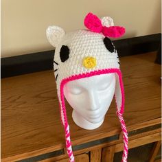 a crocheted hello kitty hat on top of a head