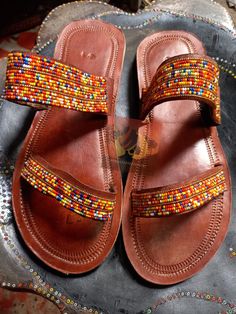 Beautifully designed African beaded sandals, Masai sandals, summer sandals, African sandals Made from fine leather and very fine beads. Available in all sizes. Kindly, using the chart provided in the pictures above, check your foot size in EUR and US sizes before placing your order. Wholesale is available upon request at a discount price. Shipping is via DHL EXPRESS with a GUARANTEED delivery between 3-5 days worldwide. **BUY MULTIPLE ITEMS, PAY SHIPPING ONCE** FREE SHIPPING FOR ALL ADDITIONAL I African Sandals, Female Sandals, African Shoes, Beaded Sandals, Christmas Gift For Her, Maasai, Designer Sandals, Beach Sandals, Christmas Gifts For Her