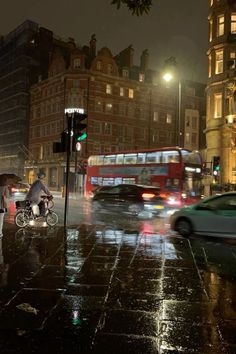 people are walking down the street in the rain