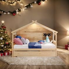 a wooden bed sitting in front of a christmas tree