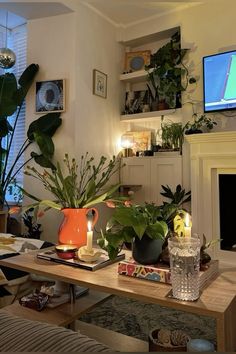 a living room filled with furniture and a fire place in front of a flat screen tv