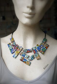 a close up of a mannequin wearing a colorful necklace