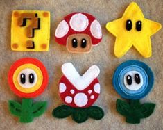 felt toys made to look like mario and luigi's mushroom friends are on the floor