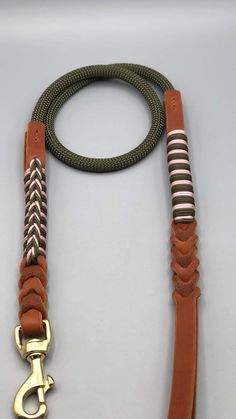 a brown and black leash on a white surface