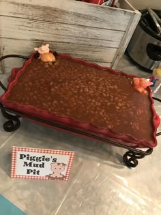 there is a cake shaped like a piggy's mud pie on the table