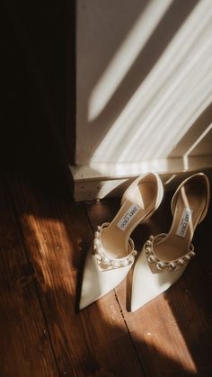 two pairs of shoes sitting on top of a wooden floor