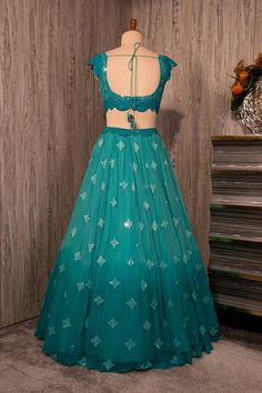 https://www.seasonsindia.com/product/peacock-bluish-green-lehenga-set-with-oablao-work-paired-with-a-matching-scalloped-dupatta-and-tikli-work-blouse/ Casual Blouse Designs, Silk Saree Blouse Designs Patterns, Simple Frock Design, Long Frock Designs, Mehendi Outfits, Long Gown Design, Simple Frocks