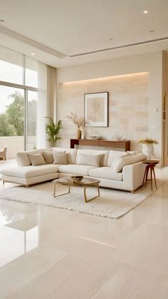 a living room with white furniture and large windows