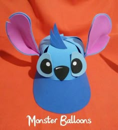 a blue paper animal with big ears on an orange background