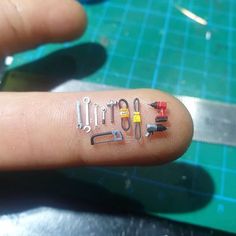 a person's finger with tools on it